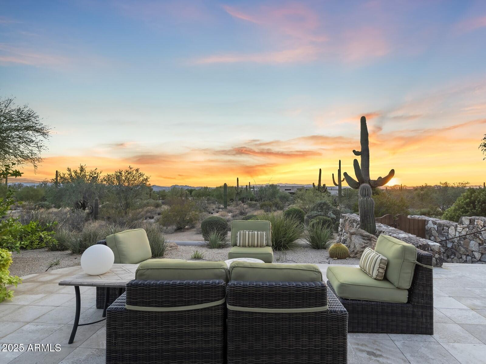 9422 East Happy Valley Road Scottsdale, AZ 85255 - Photo 74 of 99 a view of a terrace with couches and wooden fence