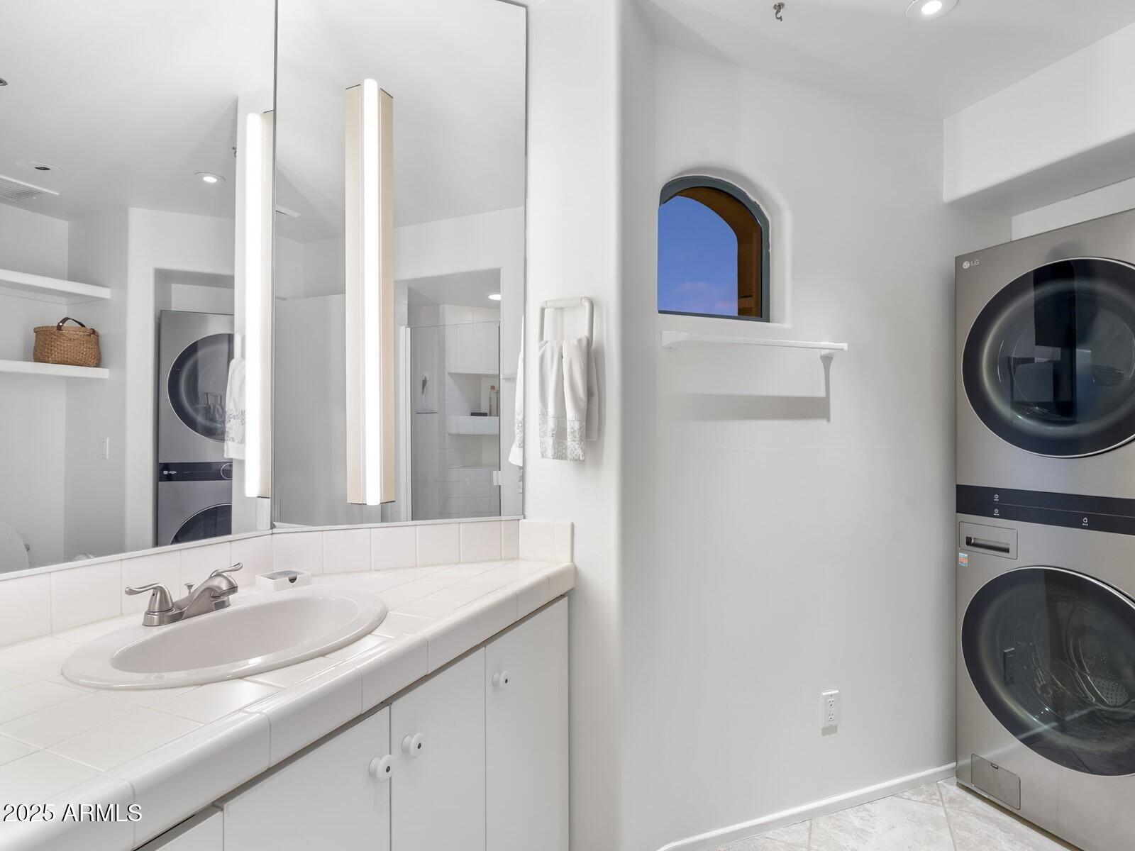 9422 East Happy Valley Road Scottsdale, AZ 85255 - Photo 95 of 99 a bathroom with a sink and a mirror