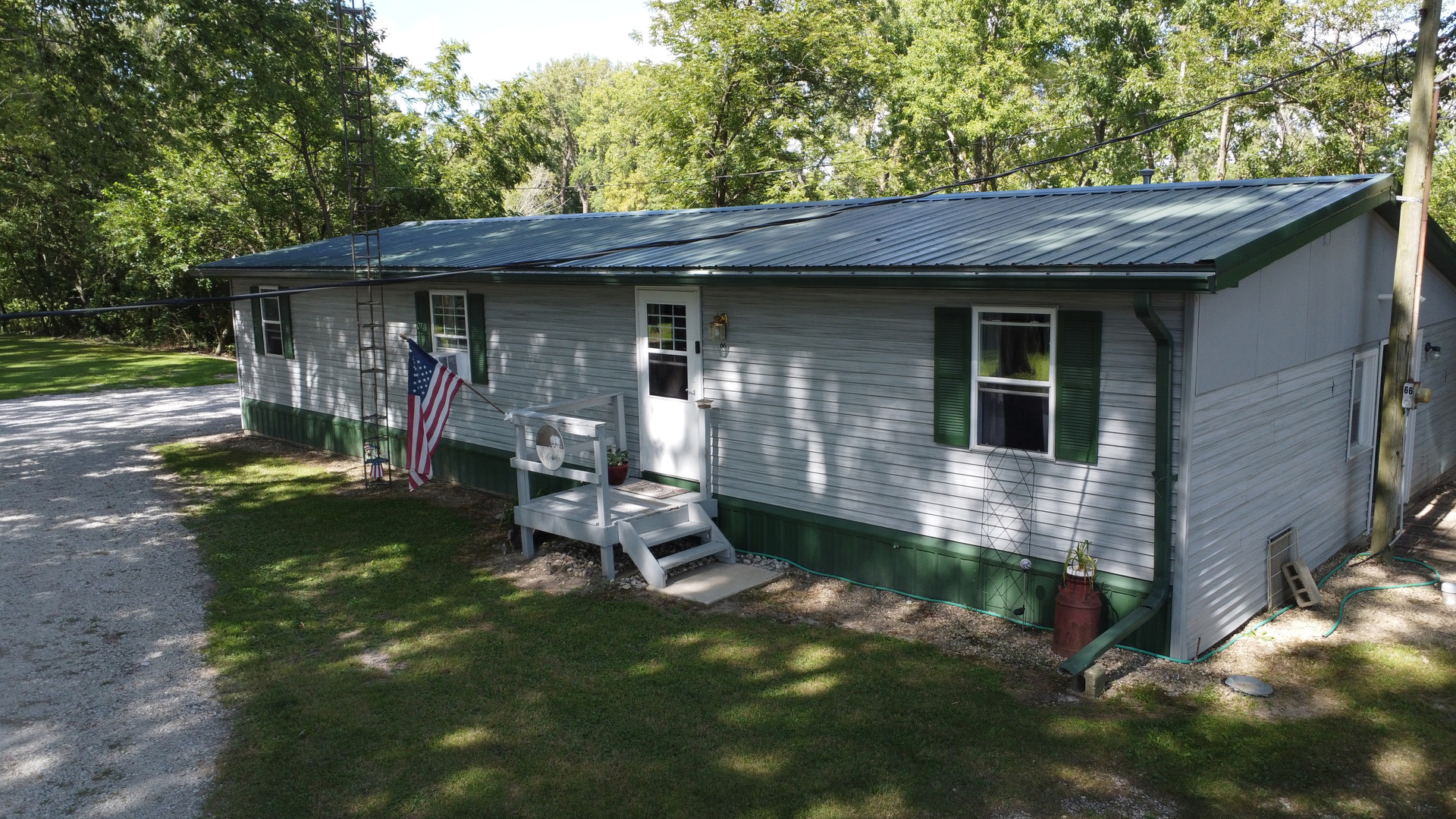 a view of a small house with a yard