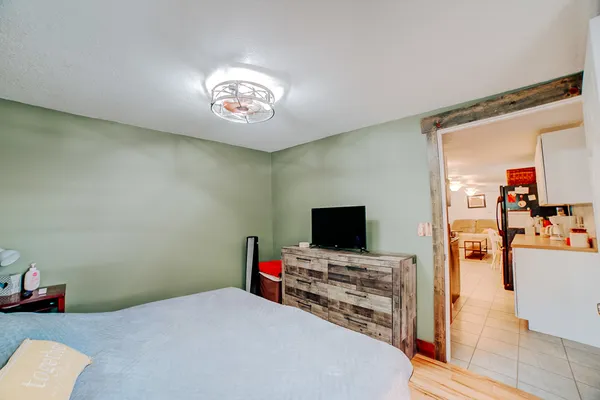 a bedroom with a bed and a flat screen tv