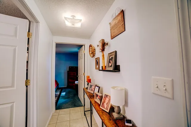 a view of a hallway with paintings on the wall