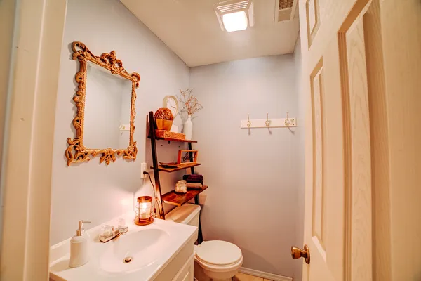 a bathroom with a sink and mirror with toilet