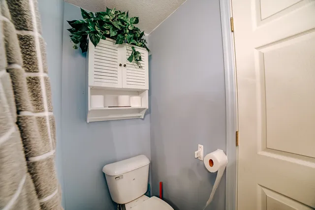 a bathroom with a toilet and a window