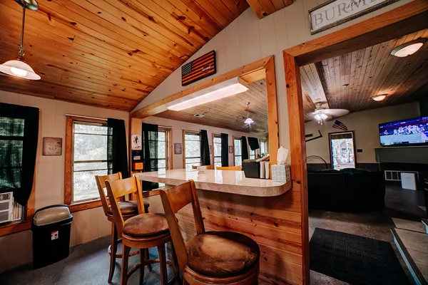 a dining room with furniture and wooden floor