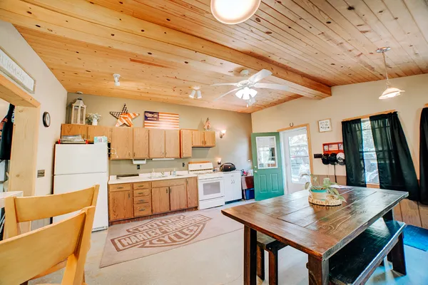 a kitchen with a table chairs and refrigerator