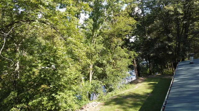 a view of a swimming pool with a yard