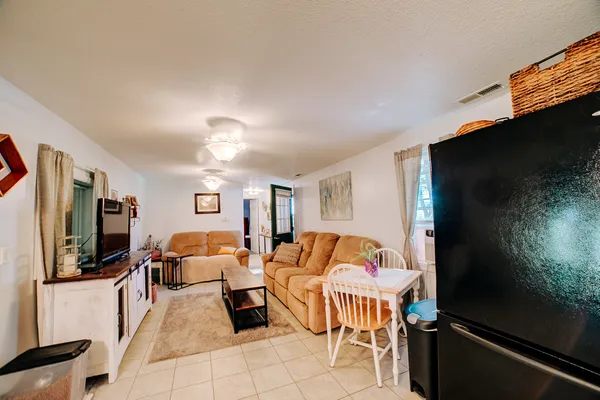 a bedroom with furniture and a flat screen tv