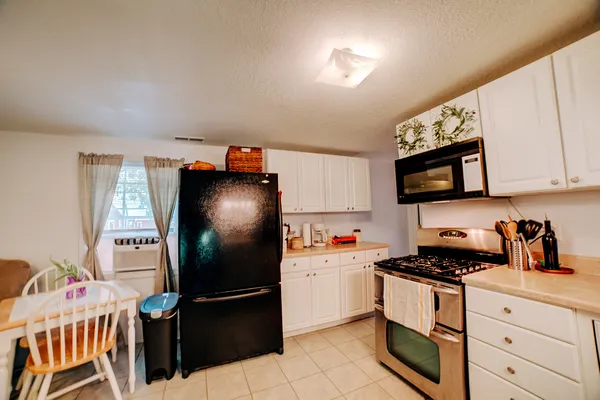 a kitchen with stainless steel appliances granite countertop a refrigerator and a stove top oven