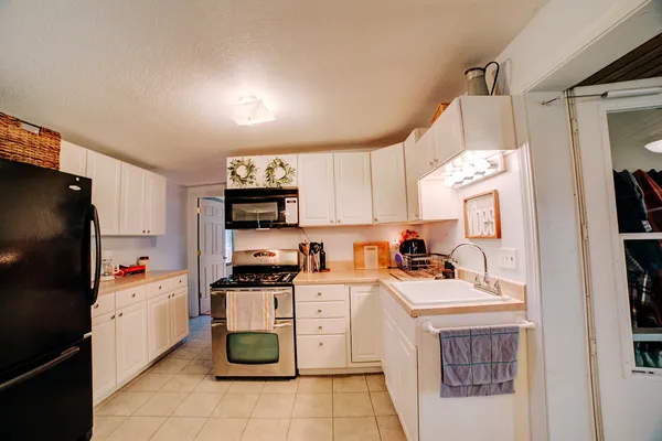 a kitchen with stainless steel appliances a stove microwave and a refrigerator
