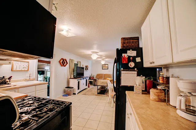 a kitchen with stainless steel appliances granite countertop a refrigerator and stove top oven
