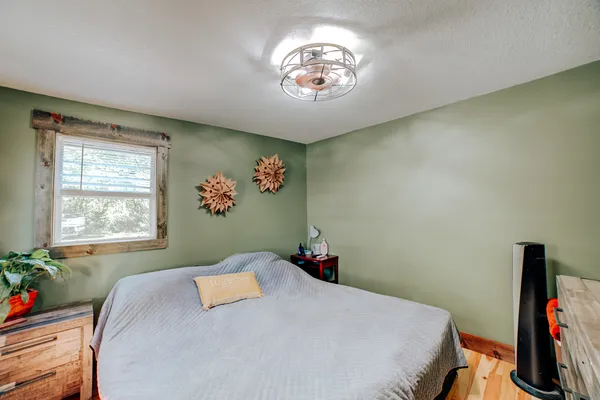 a bedroom with a bed and a chandelier