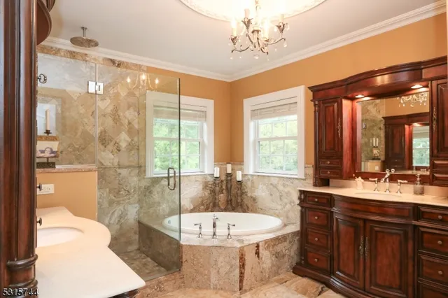 a bathroom with a double vanity sink large mirror and a bathtub