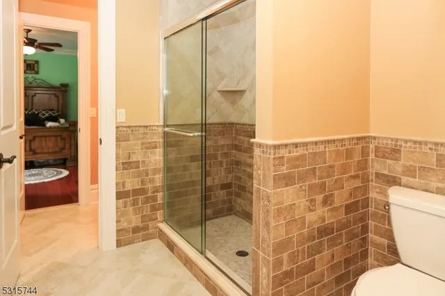 a bathroom with a shower and a toilet