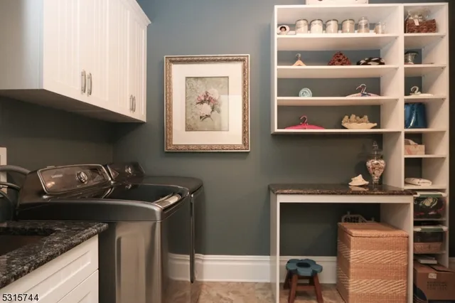 a utility room with two washing machine