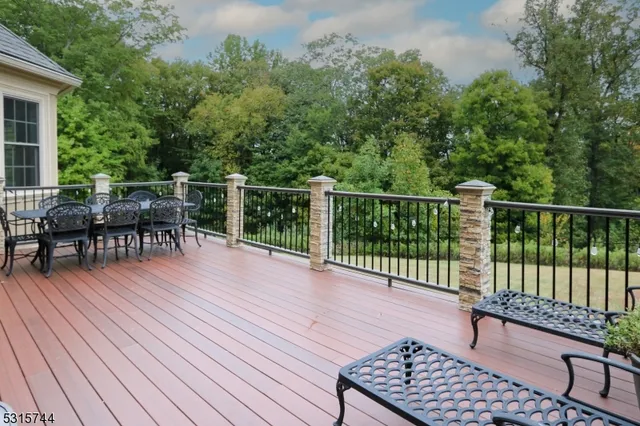 a view of a roof deck with table and chairs and wooden floor
