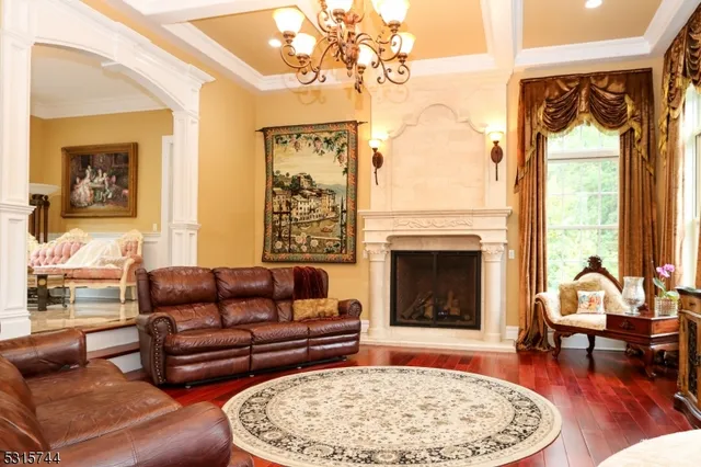 a living room with furniture a rug and a fireplace