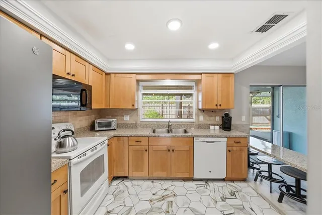a kitchen with a sink stove and cabinets