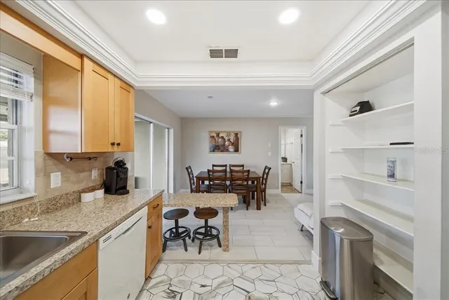 a kitchen with a sink appliances and furniture