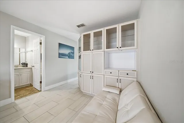 a view of a kitchen with white cabinets
