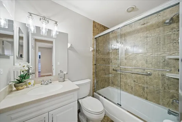 a bathroom with a sink mirror toilet and bathtub