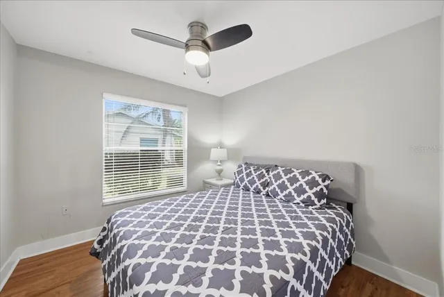 a bedroom with a large bed and a chandelier