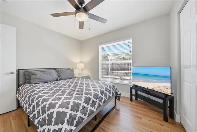 a bedroom with a bed and a window