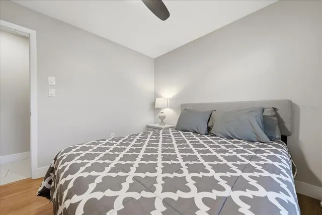 a large bed sitting in a bedroom next to a window