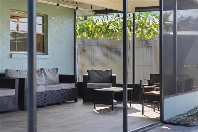 a living room with furniture and a floor to ceiling window