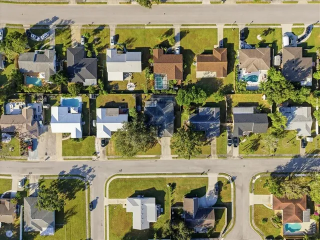 an aerial view of residential houses with outdoor space