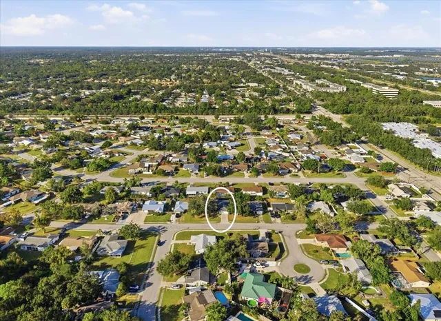 an aerial view of residential houses with outdoor space