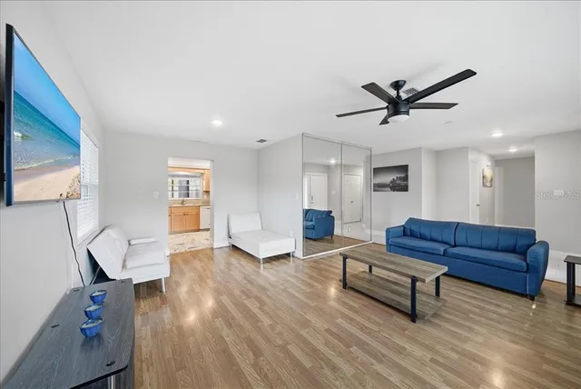 a living room with furniture and a wooden floor