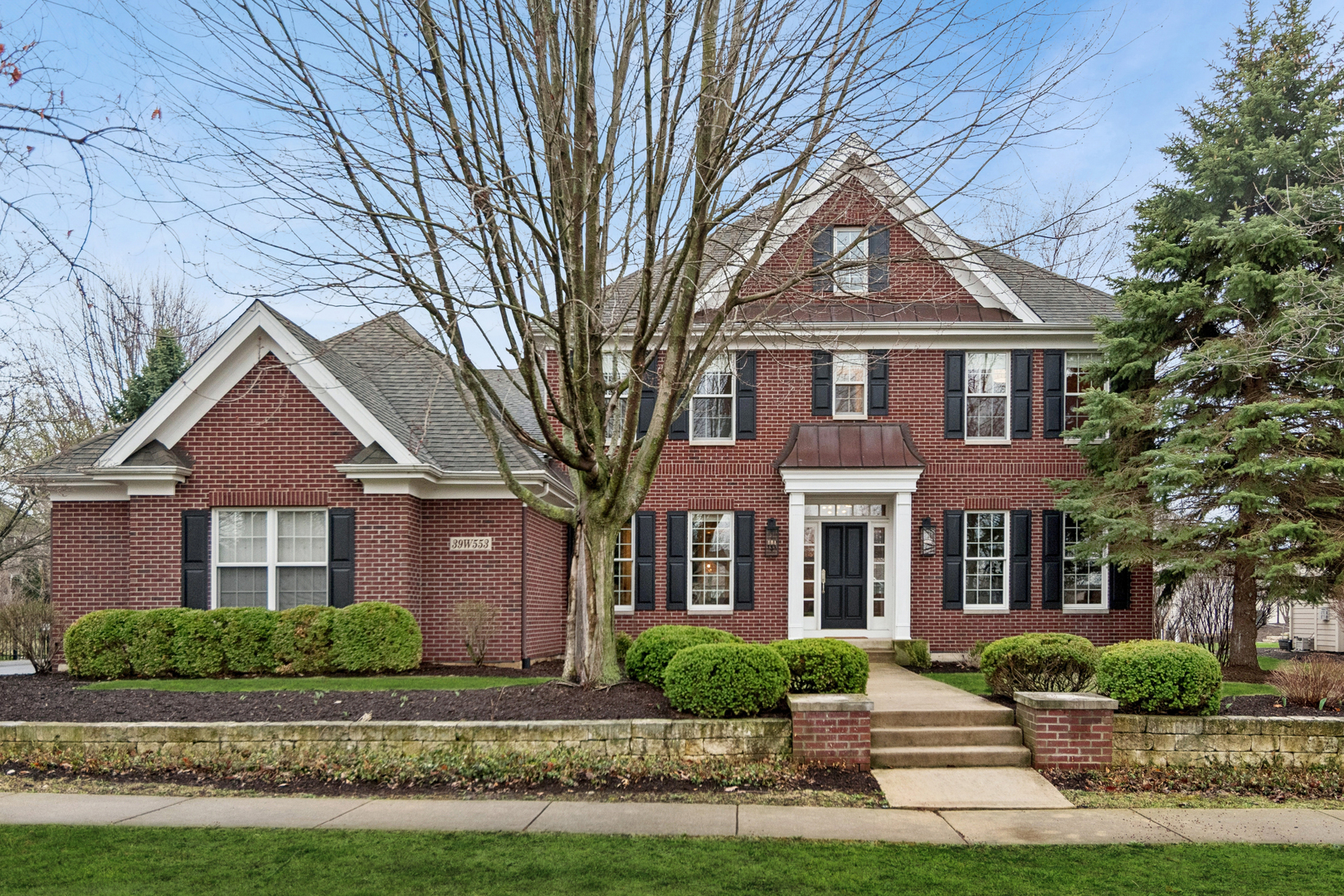 39W553 Sheldon Lane Geneva, IL 60134 - Photo 1 of 46 front view of a brick house with a yard