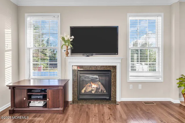 a living room with a fireplace and a flat screen tv