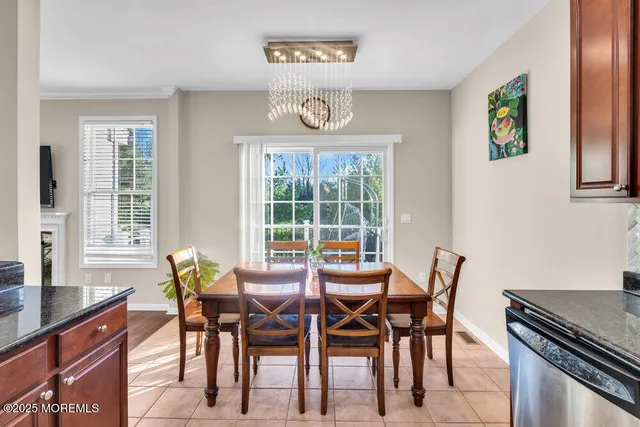 a view of a dining room with furniture and a potted plant