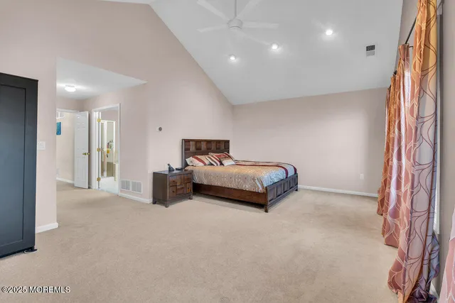 a view of walk in closet with clothes