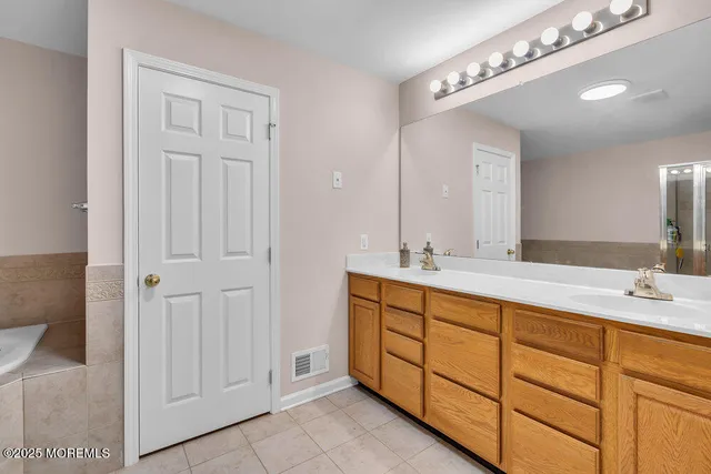 a white bath tub sitting next to a shower