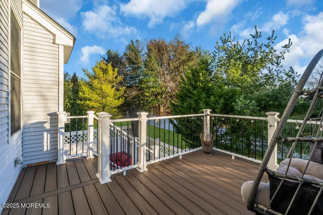 a view of balcony with wooden floor and outdoor seating