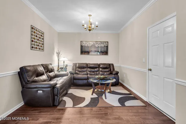 a living room with furniture and a chandelier