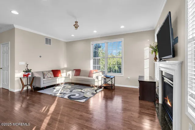 a living room with furniture fireplace and flat screen tv