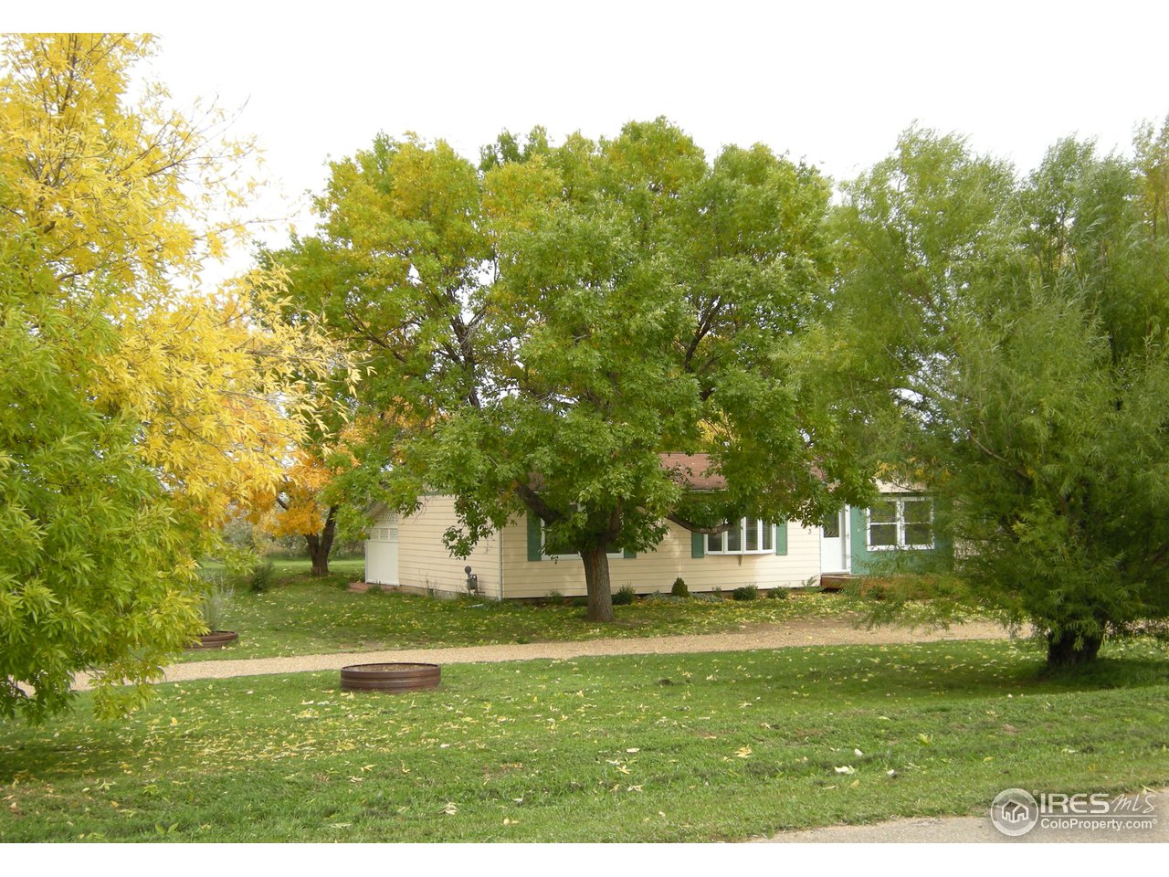 6323 Corinth Road Longmont, CO 80503 - Photo 1 of 23 Shade trees and circular driveway in front yard