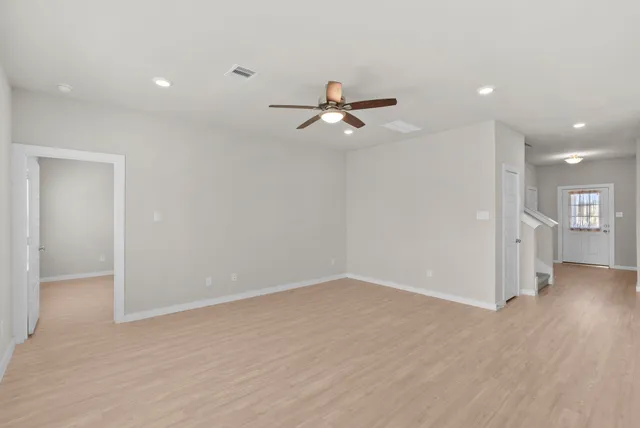 a kitchen with stainless steel appliances granite countertop a sink a stove a refrigerator a microwave and white cabinets