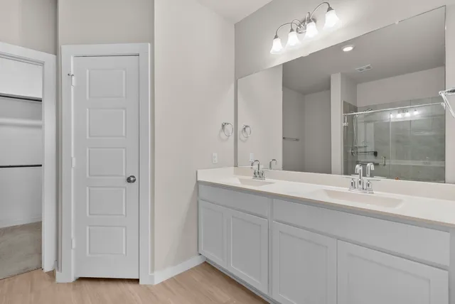a bathroom that has a glass shower door