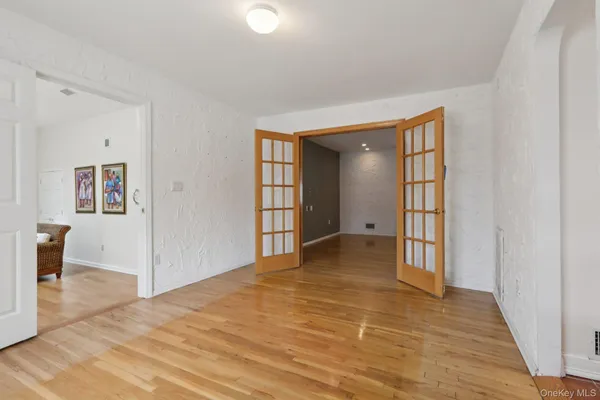 a view of a room with wooden floor and a bathroom