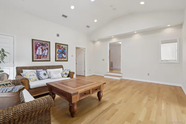 a living room with a couch and paintings on the wall