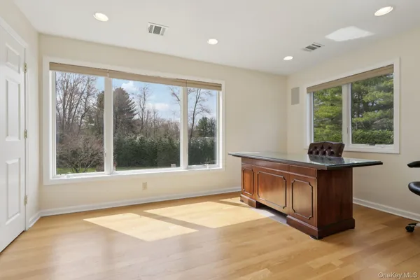 a living room with stainless steel appliances granite countertop furniture and a large window