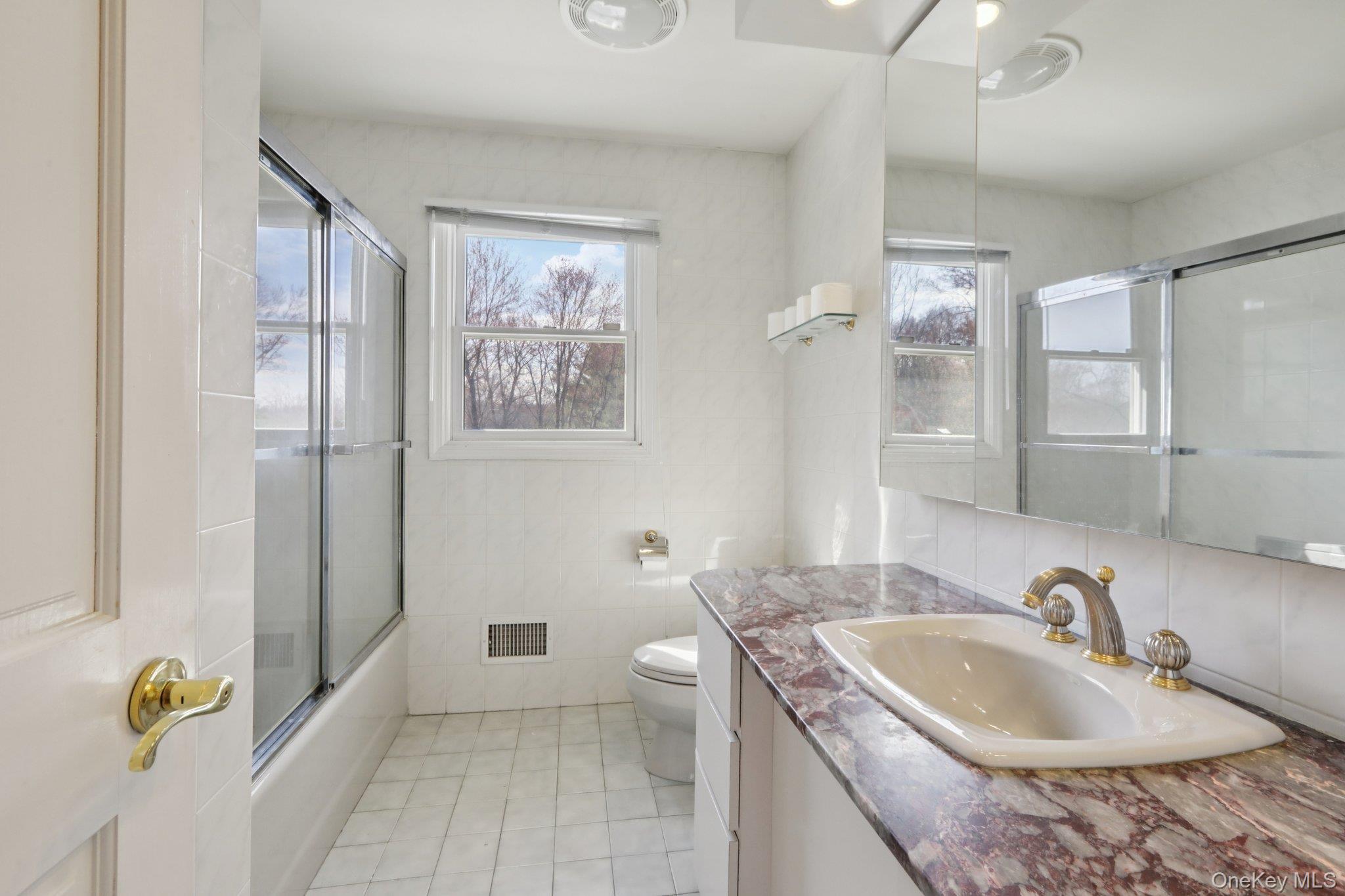 17 Rolling Ridge Road New City, NY 10956 - Photo 27 of 50 a bathroom with a granite countertop sink a toilet a mirror and shower