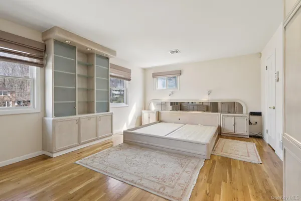 a living room with a bed and next to a window