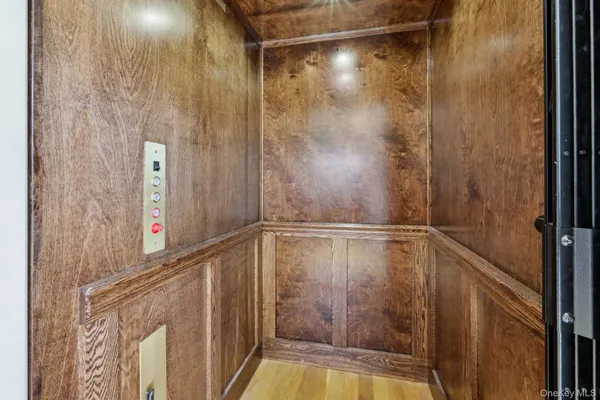 a view of a house with a big yard and large trees