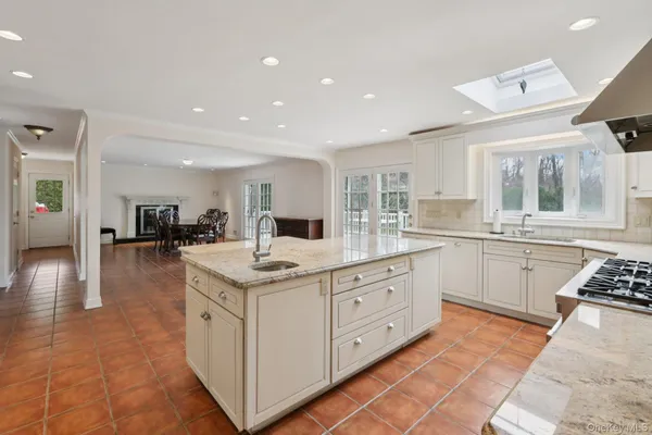 a kitchen with stainless steel appliances kitchen island granite countertop a sink and cabinets