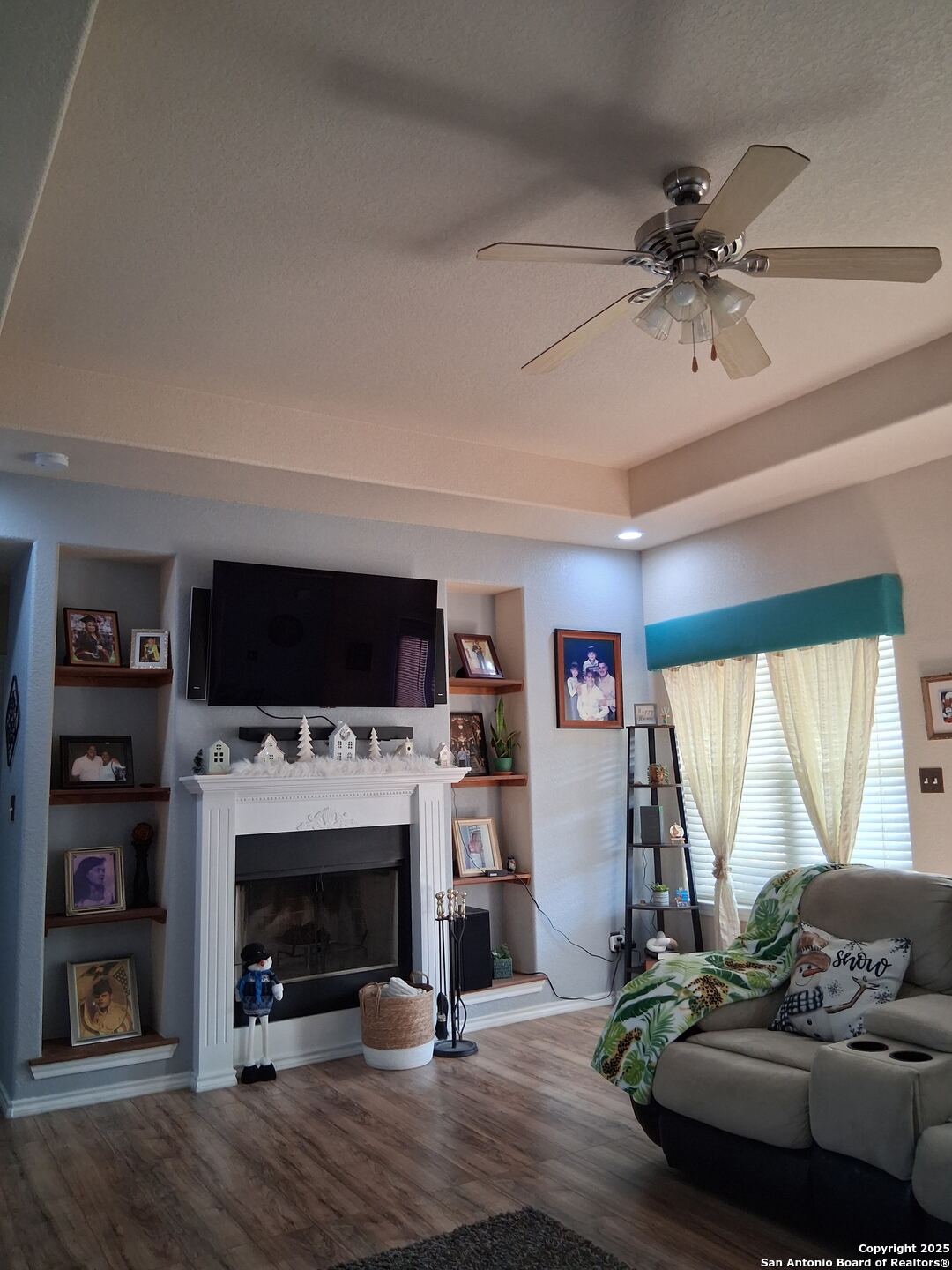 7061 Devonshire Drive Spring Branch, TX 78070 - Photo 11 of 52 a living room with furniture a flat screen tv and a fireplace